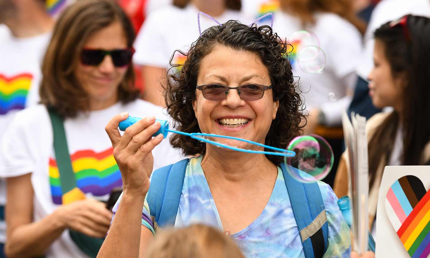 Close-up of woman at Pride parade holding a bubble wand